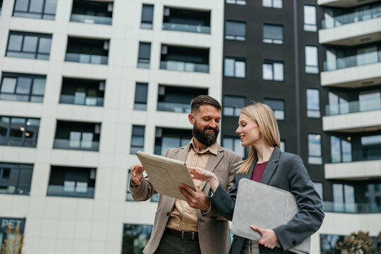 Business colleagues planning new real estate development projects outdoors
