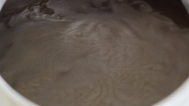 Malted barley mash swirling in a brewery tank