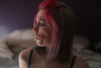 Young Woman With Pink Hair Profile Portrait Blowing Out Smoke in Soft Bedroom Light, Intimate Mood © Kenedy