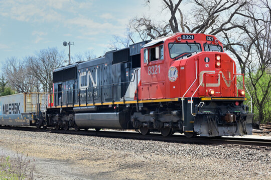 A lone locomotive leads a northbound Canadian Narional Railway stack train as it passes through northeastern Illinois.