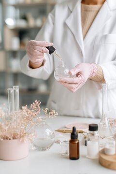 Cosmetic chemist mixing serum with dropper in lab for skincare product development and brand design use