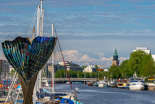 Harmonia Fountain Sculpture on Aura River With Turku Cathedral in Background, 20.5.2026 Turku, Finland. 