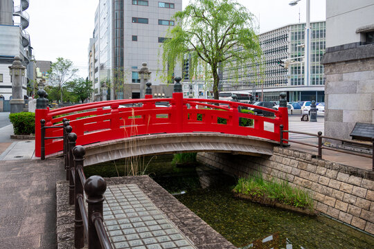 The iconic red wooden Harimayabashi Bridge over a small canal in Kochi, Japan