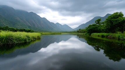 Obraz premium Misty mountain landscape with lush green valleys and rolling hills under an overcast sky
