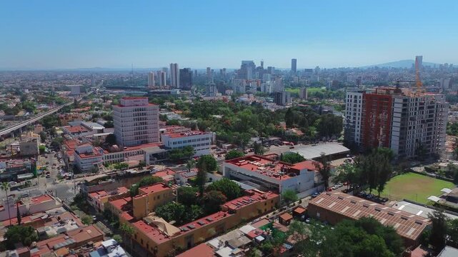 Modern Corporate District Skyline of Zapopan Featuring a Cinematic Aerial Drone Forward Push In View Under a Clear Blue Sky in Jalisco Mexico