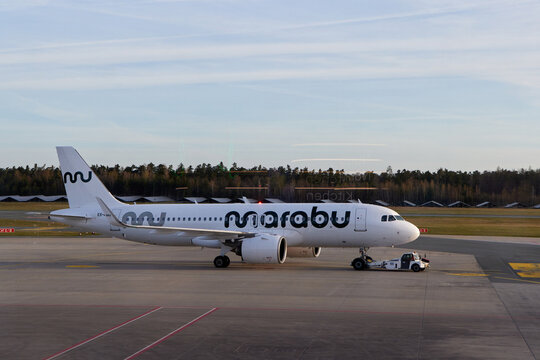 Marabu Airlines Airbus A320 airplane being towed by a pushback tractor at Nuremberg Airport.