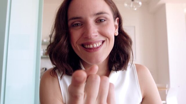 Video call, home and face of woman with sign language for communication, contact and networking. Happy portrait, wave or pov of person with I miss you gesture for conversation, chat and online dating
