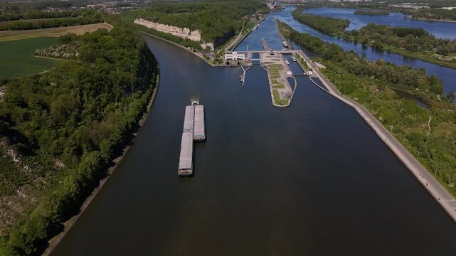 River lock on the Maas at the border of Belgium and Netherlands with a barge on the Albert Canal