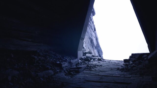 Highcontrast internal view toward bright sky, debrisstrewn floor and steep concrete walls, quiet observational mood like scout or photographer stakeout,
