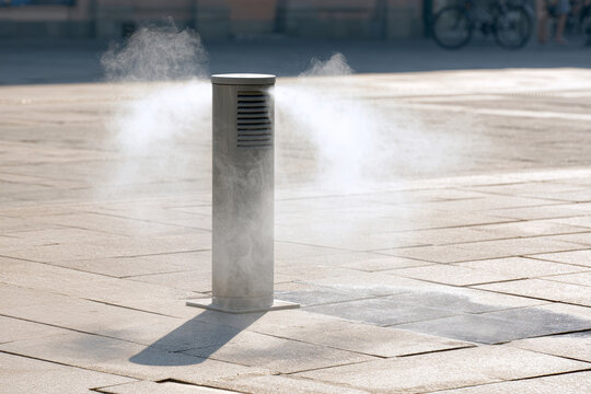 Urban cooling mist system operating on a hot summer day, representing heatwave adaptation, public cooling infrastructure and climate resilience in the city