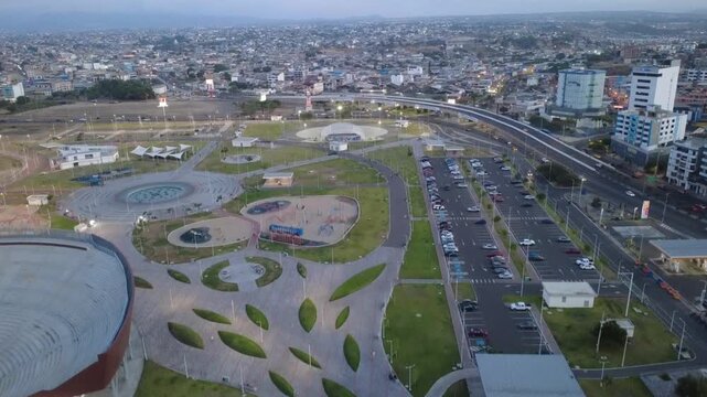 Drone footage of the bridge de la cultura in Manta, Ecuador with traffic and urban neighborhoods.
