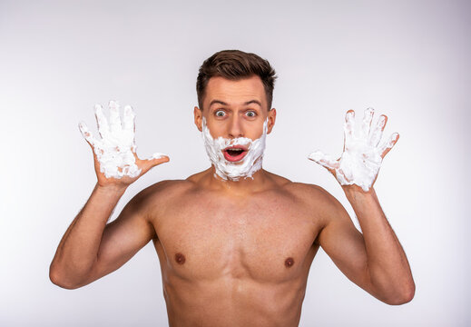 Surprised man with shaving foam.