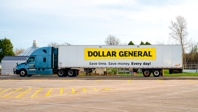 Syracuse, NY - Apr 14, 2026: A Dollar General tractor‑trailer parked in a lot, featuring the company&rsquo;s yellow‑and‑black branded trailer with the &ldquo;Save time. Save money. Every day!&rdquo; slogan