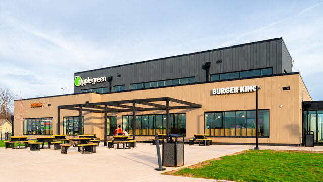 Brutus, New York - Apr 14, 2026: Exterior of the Applegreen‑operated Port Byron Service Area on the New York State Thruway. The plaza features Applegreen branding, Burger King and Dunkin&rsquo; storefronts