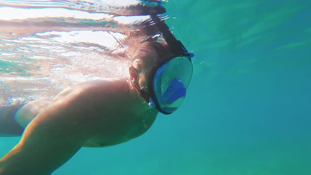 Man Snorkeling Underwater in Clear Turquoise Sea with Full Face Mask