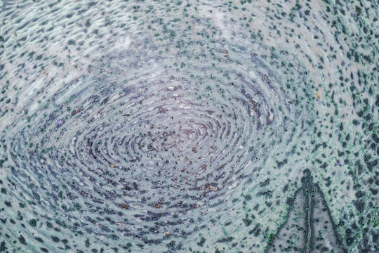 Macro of unique tinguaite rock polished surface from Khibiny forming a microscopic landscape with a forest swamp swirl pattern, 15 mm field of view