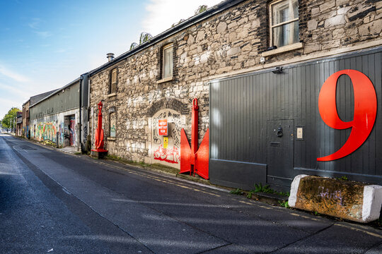 Exterior view of 9 Hanover Quay, former warehouse once U2 recording studio, now covered in murals and street art in the Docklands district, Dublin, Ireland.