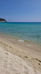 Obraz premium Beautiful sunny day with crystal-clear water and white sand at Spiaggia Solanas, Sardinia