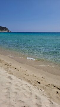 Beautiful sunny day with crystal-clear water and white sand at Spiaggia Solanas, Sardinia
