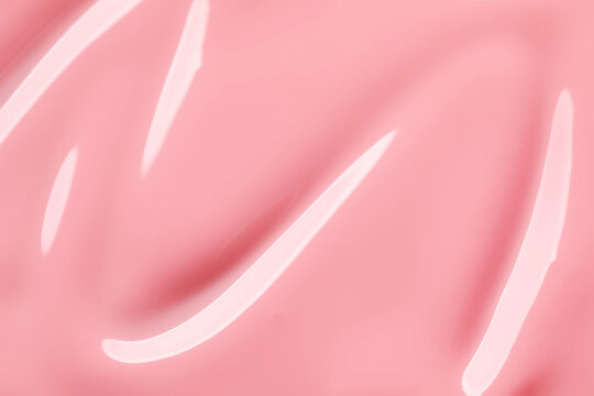 Pink nail polish as background, top view