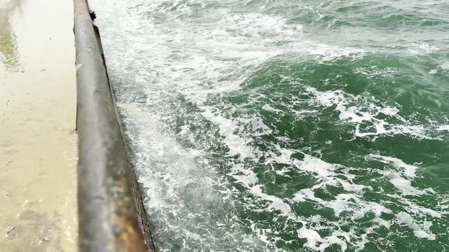 seafarers washing vessel. water leaking from ship deck to the sea