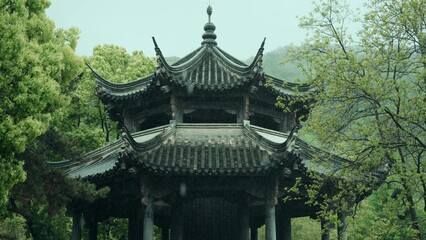 Obraz premium Double decker ancient pavilion in Jiangnan garden surrounded by lush green trees