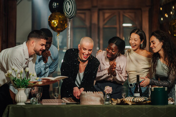 Fototapeta premium Diverse friends celebrating birthday, cutting cake, laughing and enjoying fun party with balloons and gifts