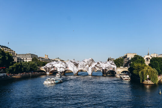 Paris, France - May 21, 2026: The historic Pont Neuf bridge transformed by French artist JR into a monumental cave-inspired temporary public art installation
