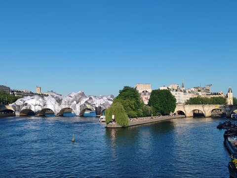 Paris, France - May 21, 2026: The historic Pont Neuf bridge transformed by French artist JR into a monumental cave-inspired temporary public art installation