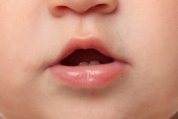 Fototapeta premium Cute child with first baby teeth, closeup
