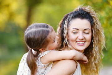 Fototapeta premium Mother with her cute little daughter in nature, closeup