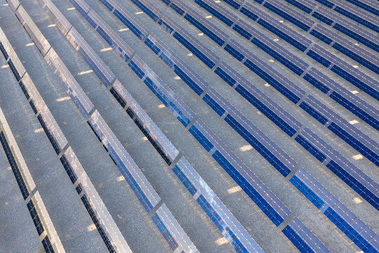 Aerial view of rows of blue solar panels reflecting the sunlight in a solar farm Enterprise, Nevada, United States.