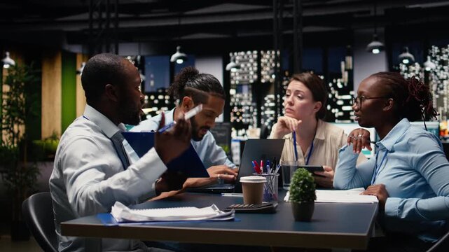 Company manager leading diverse team, fostering positive office culture of operational efficiency. Team leader in workspace supervising administrative staff, setting performance goals.