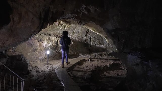 Woman Explorer Walking Through Dark Yagodinska Cave Slow Motion