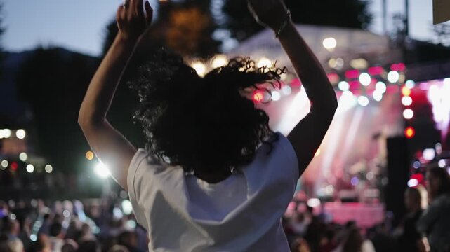 Jumping Woman Dancing at Outdoor Music Concert in Slow Motion