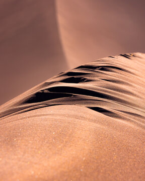 View of the wind-sculpted ridges and fine textures of a sand dune in the Valley of the Moon, San Pedro de Atacama, Antofagasta, Chile.