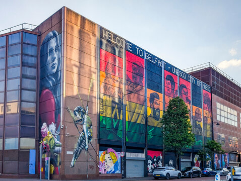 Belfast, UK, May 6, 2026. The street view of vibrant art mural on the historic Telegraph Building on Donegall Street, with text "Welcome to Belfast - UNESCO City of Music."