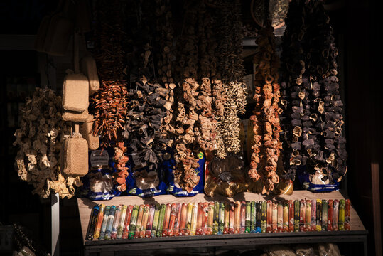 View of strings of dried eggplants, peppers, and okra hanging in a traditional market stall with dramatic sunlight Kayseri, Kayseri, Turkiye.
