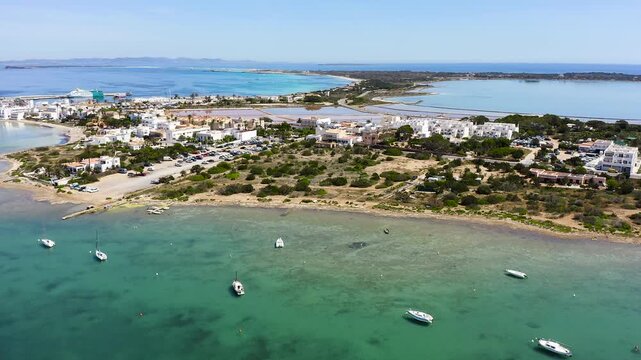 Aerial view of Estany des Peix lagoon and La Savina coastline in Formentera island, Spain.