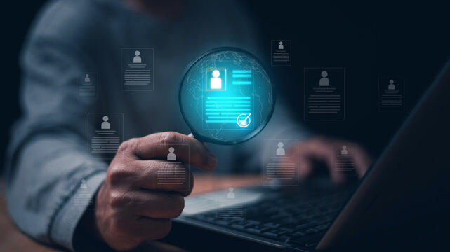 Businessman using magnifying glass with virtual identity verification. Profile screening, digital background check, KYC verification, user authentication and global identity validation concept.