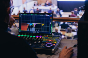 Lighting technician operator working on mixing console, workplace during live event, stage concert show broadcast, light mixer controller panel, sound technician with professional equipment at venue © tsuguliev