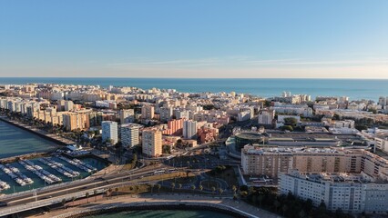 Aerial view of the Constitution of 1812 Bridge in Cadiz, Spain. Cinematic drone shot of the modern landmark cable-stayed bridge over the bay on a sunny day