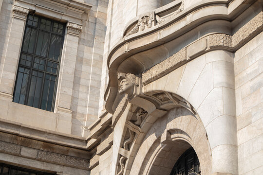 Close-up of an ornate architectural detail on a historic building featuring sculptural elements and curved stone forms.