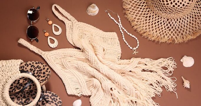 Beachwear and different accessories on brown background, flat lay