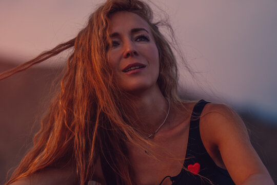 Young romantic woman portrait at sunset warm light