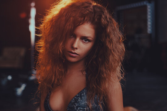 Portrait of a beautiful redhead woman with messy hair and freckles