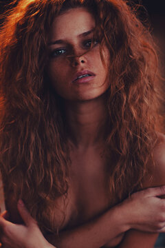 Beautiful redhead woman with freckles and wild curly hair portrait