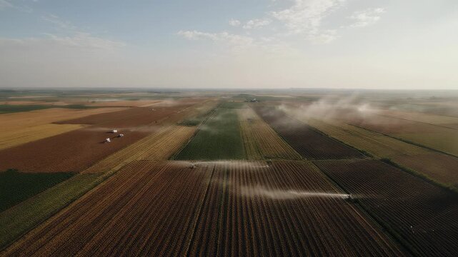 Drone surveys expansive agricultural fields utilizing advanced irrigation systems for sustainable crop growth.