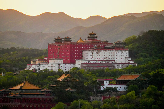Putuo Zongcheng Temple complex, the historic Little Potala Palace at sunset with distant mountains, Chengde, Hebei, China