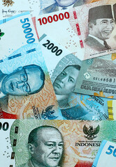 Indonesian rupiah money banknotes pile on table. Indonesia bills of IDR currency close up © Larysa